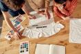 Creative,people,trying,on,stickers,with,text,,while,discussing,logo